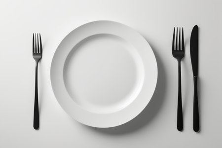 there is a plate with a fork and a knife on itの素材