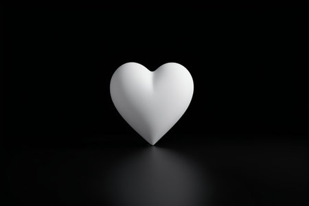 a close up of a white heart shaped object on a black surfaceの素材