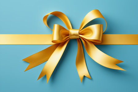 a close up of a gold bow on a blue backgroundの素材