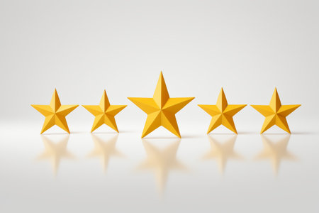five gold stars are lined up in a row on a white surfaceの素材