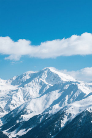 Snowy mountain scenery under blue sky and white cloudsの素材