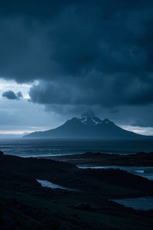 Mountain landscape shrouded in dark clouds by the seaの素材