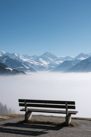 Bench view under the snow-capped mountainの素材