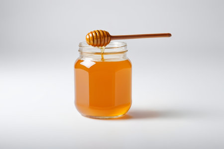 Close-up of glass jar honey and honey sticksの素材