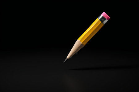 Yellow pencil on black backgroundの素材