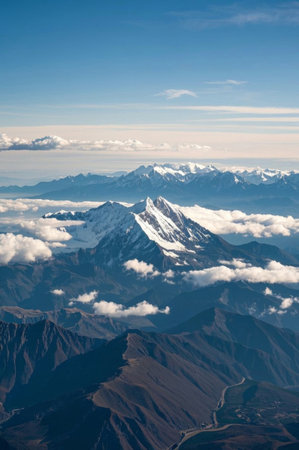 High-altitude view of the snow-capped mountains and sea of cloudsの素材