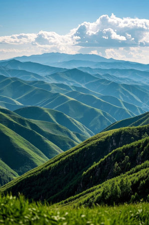 Continuous green mountains and blue sky and white clouds sceneryの素材