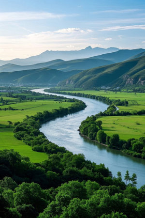 Green pastoral scenery beside the winding riverの素材