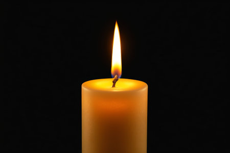 Close up of a burning cylindrical candleの素材