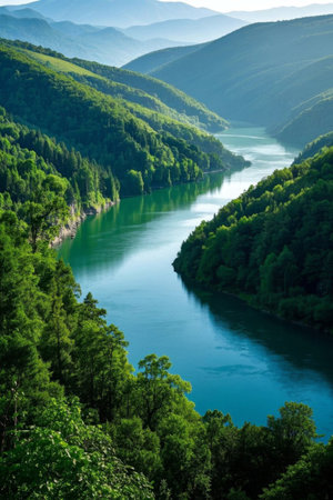 River valley scenery with green mountains and green waterの素材