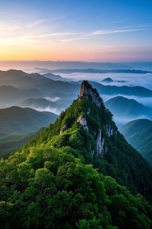Panoramic view of the sunrise over the sea of clouds and green mountainsの素材