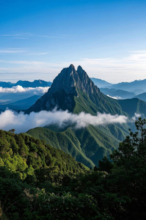 Towering mountains in a sea of green mountains and cloudsの素材