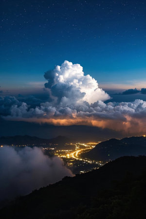 Cities and mountain scenery in the clouds under the night skyの素材