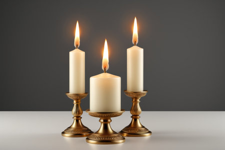 Three lit candles are placed on the candlestickの素材