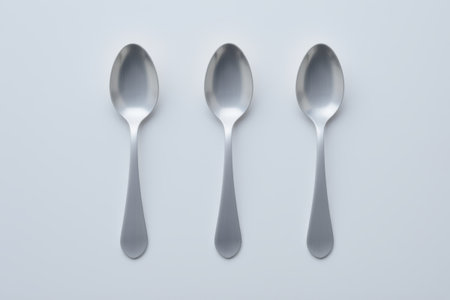 Close-up of three stainless steel spoonsの素材
