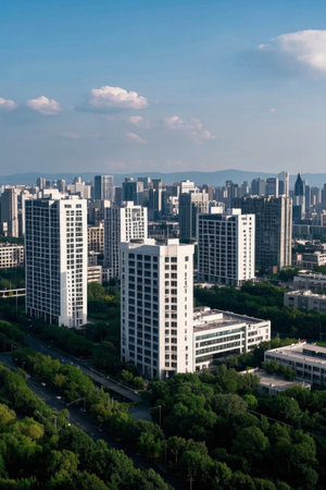 Aerial view of the city's tall buildings and green treesの素材