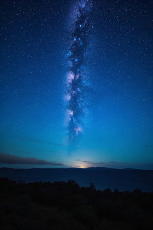 The Milky Way and distant mountain landscapes under the night skyの素材