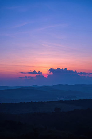 Beautiful scenery of distant mountains and sky at sunsetの素材