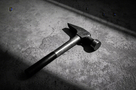 Metal hammer on cement floorの素材