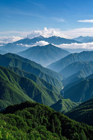 Landscape of continuous mountains under blue sky and white cloudsの素材