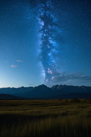 Starry sky and mountain landscape on the grasslandの素材