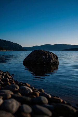 Lonely rocks by the lake and distant mountain sceneryの素材