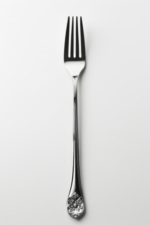 Close up of silver patterned forkの素材