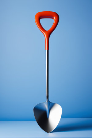 Close up of a red handled metal shovelの素材