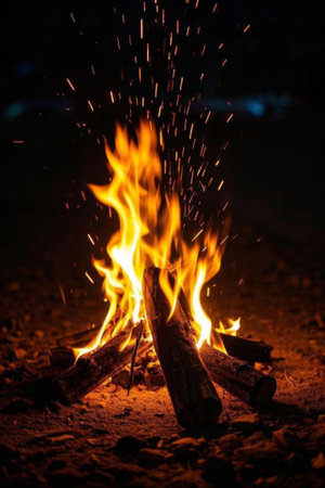 A roaring bonfire outdoors at nightの素材