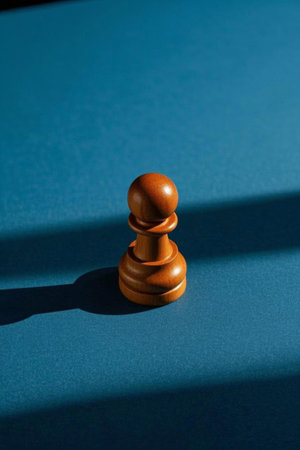 Wooden chess pieces on a blue chessboardの素材