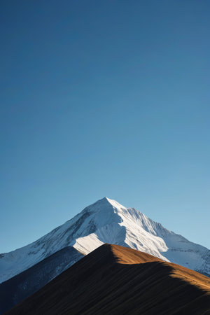 Towering snow capped mountains and blue skiesの素材