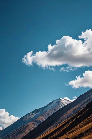 Continuous mountains under blue sky and white cloudsの素材