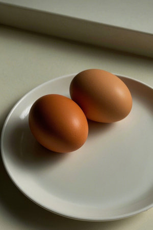 Two eggs on a white plateの素材