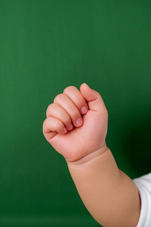 Close up of baby making a fistの素材