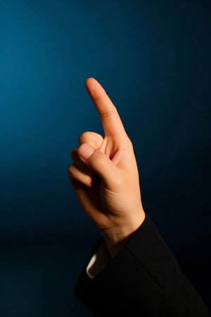 Close up of hand index finger pointing upwardsの素材