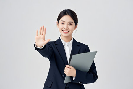 Business woman says hello with folderの素材