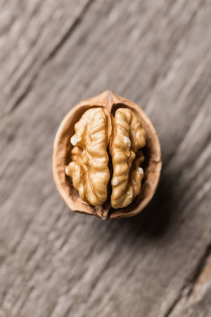 Peeling walnuts on a wooden tabletopの素材