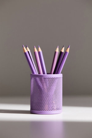 Multiple pencils inserted into the purple pen holderの素材