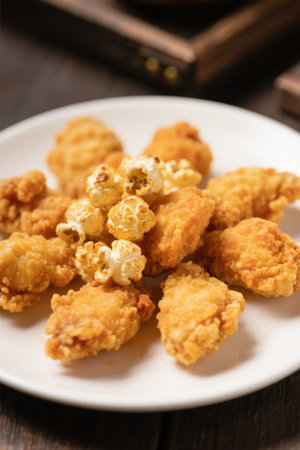 Fried chicken with popcorn on a plateの素材
