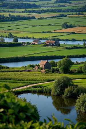 Rural pastoral river and farmhouse landscapeの素材