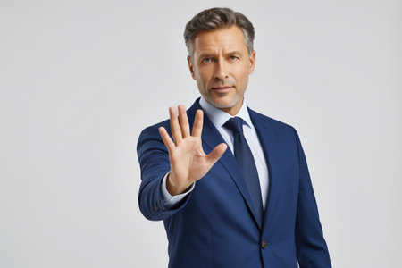 Suit man makes stop gestureの素材