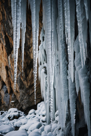 Icicles and snow hanging on the rock wallの素材