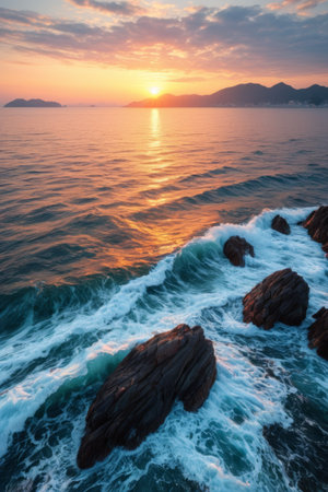 Waves crashing against rocks at sunset on the beachの素材