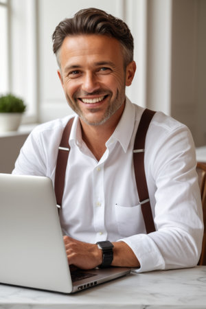 Business man smiling with laptopの素材