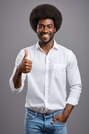 Black man gives thumbs up and smilesの素材