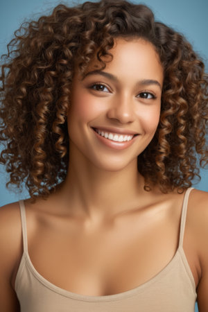 Close up of curly haired woman smilingの素材