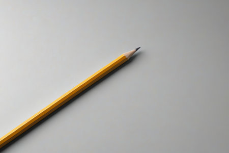Yellow pencil on a gray backgroundの素材