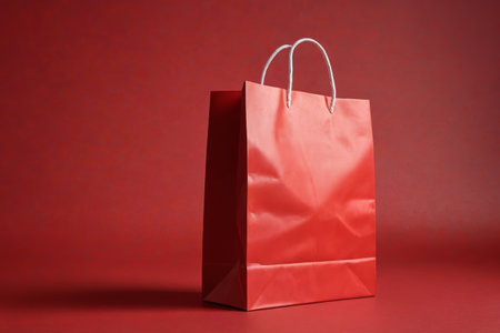 Close up of shopping bags against a red backgroundの素材