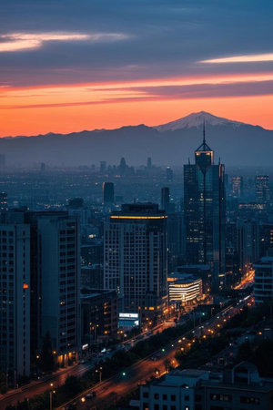 Sunset view of city skyscrapers and distant mountainsの素材