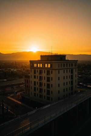 Overlooking the city buildings at sunsetの素材